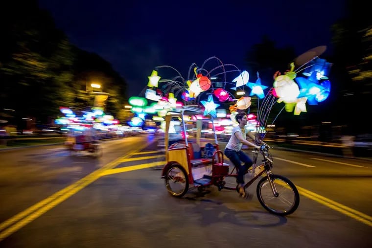 Workers test a pedicab illuminated with lanterns for Cai Guo-Qiang’s “Fireflies,” a work of art you can ride on — there will be a whole fleet — by the Chinese artist who did the fireworks for the Beijing Olympics.