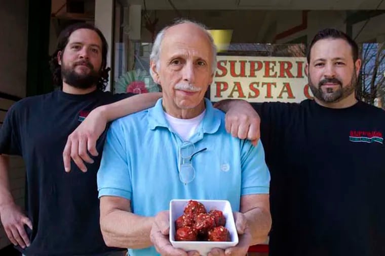 Rodger Holst (left), Joe Lomanno Sr. (holding a bowl of vegan meatballs), and Joe Lomanno Jr. outside of Superior Pasta.  ( CHARLES FOX / Staff Photographer )