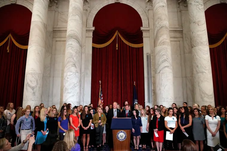 Sen. Jerry Moran, R-Kansas, center left, and Sen. Richard Blumenthal, D-Conn., attend a news conference with dozens of women and girls who were sexually abused by Larry Nassar, a former doctor for Michigan State University athletics and USA Gymnastics on Capitol Hill in Washington.