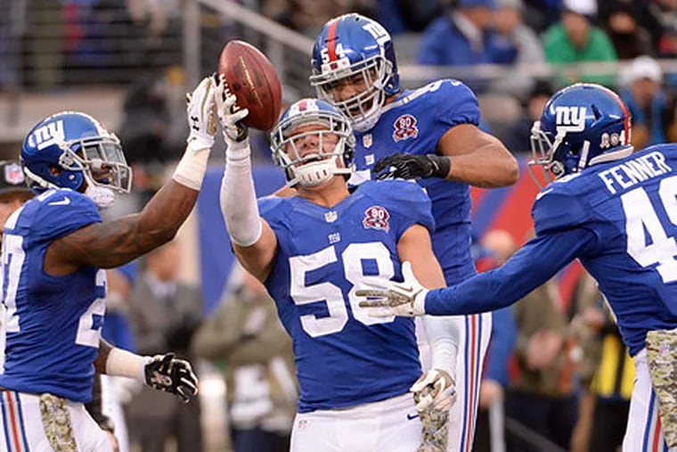 New York Giants middle linebacker Mark Herzlich (58) celebrates after taking control of a loose ball on an onside kick. (Robert Deutsch/USA TODAY Sports)