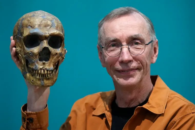 Swedish scientist Svante Paabo poses with a replica of a Neanderthal skeleton at the Max Planck Institute for Evolutionary Anthropology in Leipzig, Germany, on Monday.