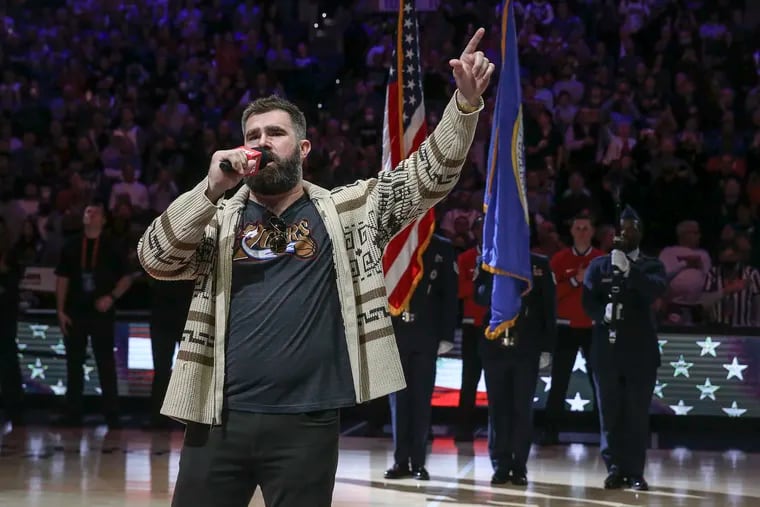 Eagles Jason Kelce singing the national anthem before the Sixers-Nuggets game at the Wells Fargo Center in 2022 after $100,000 was raised for Connor Barwin's Make the World Better Foundation. Kelcoe is dressed as the Dude from "The Big Lebowski."