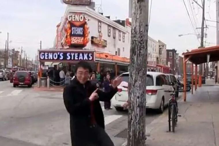 Filmmaker Jerry Liu (above) went out and video'ed his Philly-centered "Happy" tribute, complete with cheesesteaks and dancing locals (below, left). Over at the school district building, worker Chris Hawkins led a crew with some intricate foot- and props-work.