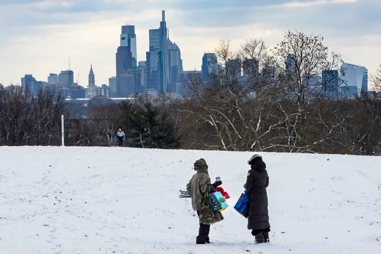 Sledders at Belmont Plateau, in Fairmount Park, as snow fell earlier this month. So far, threats have outweighed actual snow.