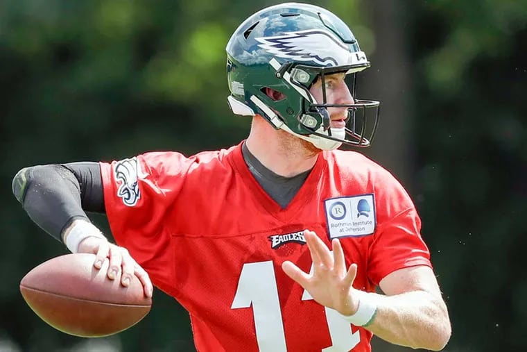 Eagles quarterback Carson Wentz wears a jersey with a Rothman/Jefferson patch during practice last week.
