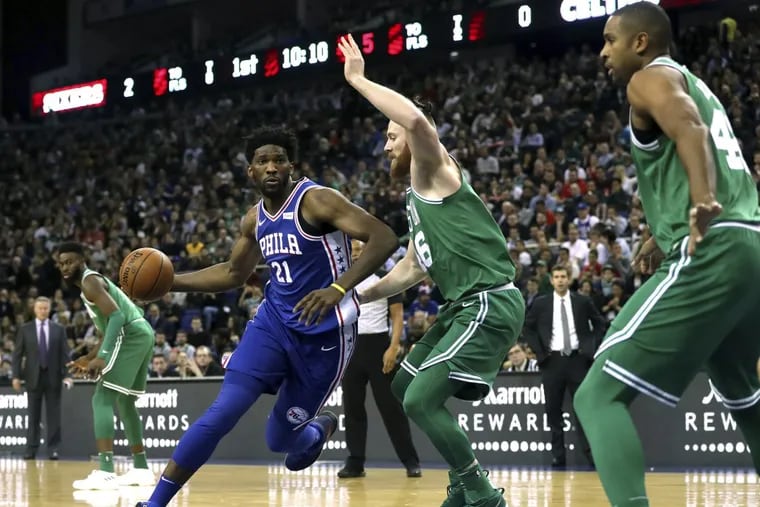 Sixers’ center Joel Embiid, (left) and Celtics’ big man Aron Bynes in action during the NBA London Game 2018 at the O2 Arena in London, Thursday Jan. 11.