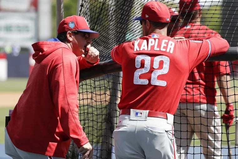 Phillies manager Gabe Kapler talks with bench coach Rob Thomson during batting practice before the Phillies play the New York Yankees in a spring training game at George M. Steinbrenner Field in Tampa on Thursday, March 8, 2018.