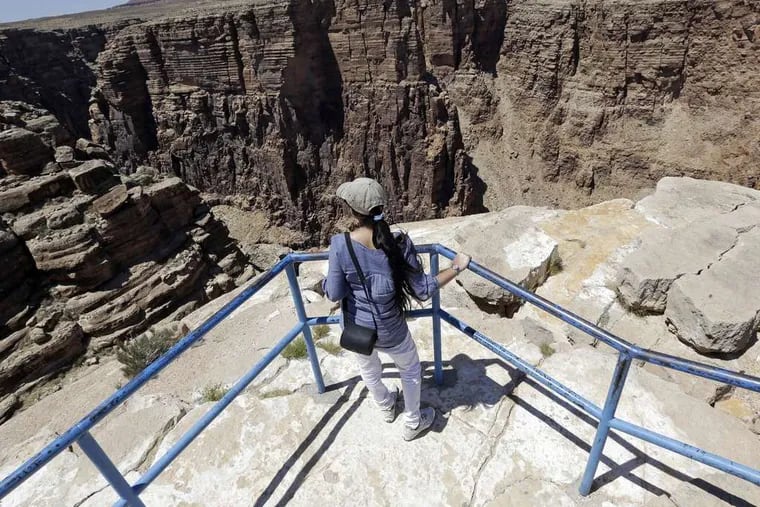 Little Colorado River Gorge is where Nik Wallenda performed his tightrope act Sunday. A tourist was taking in the viewfrom the Navajo reservation near Cameron, Ariz., on Saturday.