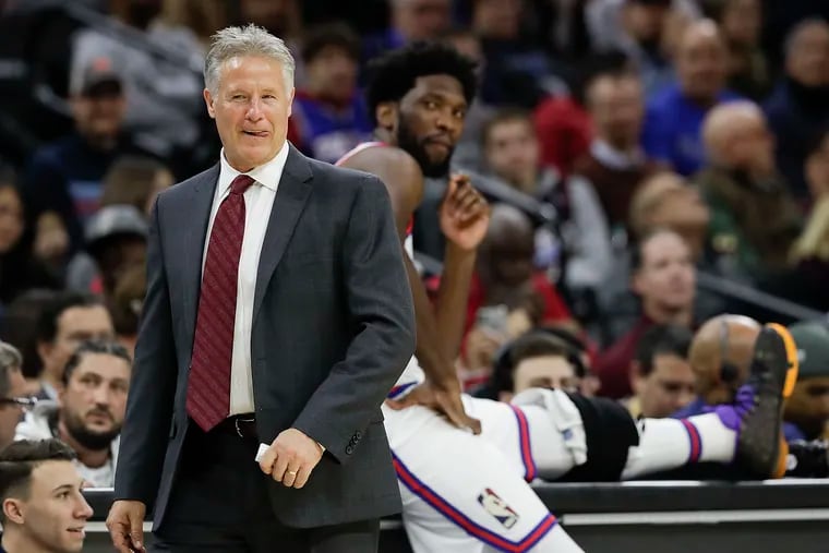 Former Sixers coach Brett Brown during a lighthearted moment with center Joel Embiid in November 2019.