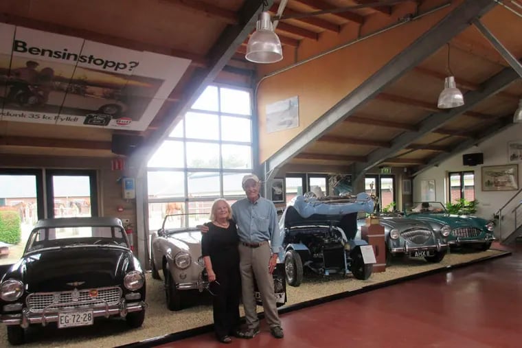 Marlyn and Randy Alkins are right in their element in the Healey Museum in Amsterdam, in front of a line of classic Austin-Healeys. Randy has owned Healeys since the 1960s and recently bought a 1961 example.