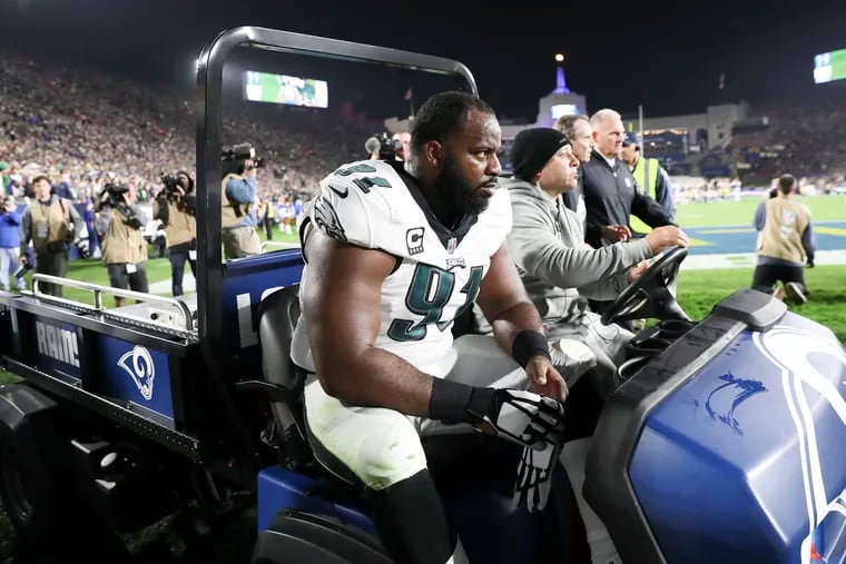 Fletcher Cox gets carted off the field during the second quarter on Sunday. He returned and laid down a big-time sack on Jared Goff.