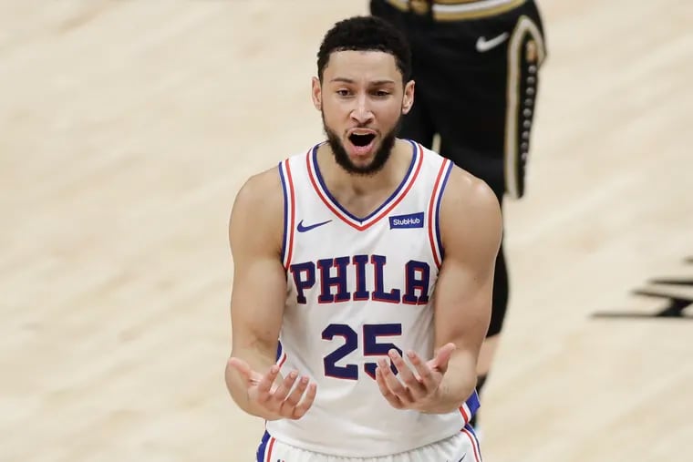Sixers guard Ben Simmons raises his hands after committing a foul has been fined, again, by the team.