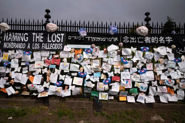 A fence outside Brooklyn's Green-Wood Cemetery is adorned with tributes to victims of COVID-19 in New York. The memorial is part of the Naming the Lost project which attempts to humanize the victims who are often just listed as statistics. The wall features banners that say "Naming the Lost" in six languages — English, Spanish, Mandarin, Arabic, Hebrew, and Bengali.