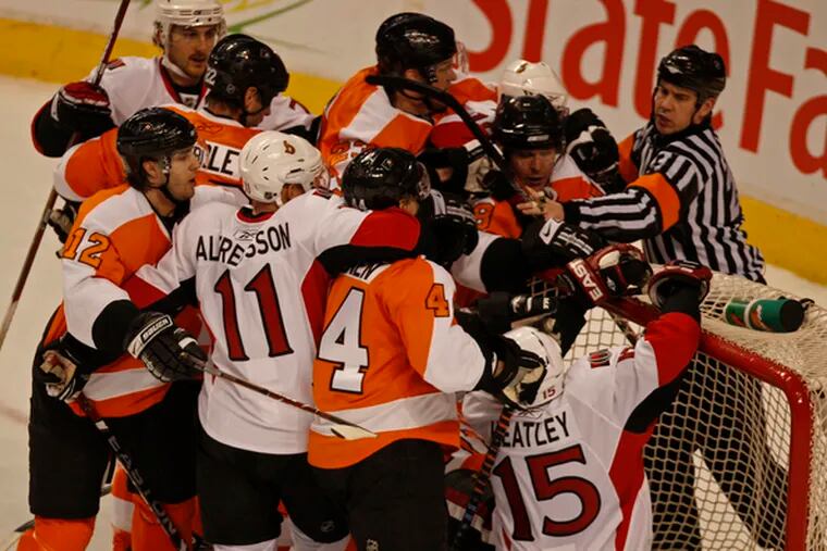 Flyers and Senators debate around Flyers&#0039; net and goalie Antero Niittymaki during third period.