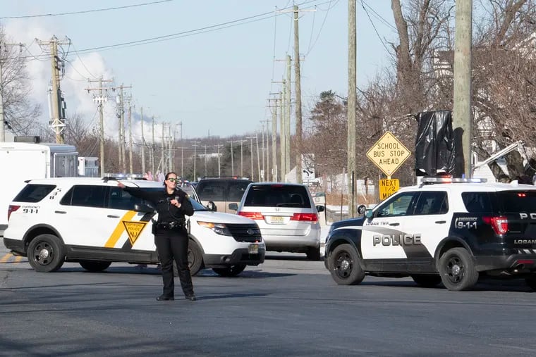 Police redirect traffic near the location of a report of an active shooter situation at a UPS facility in Gloucester County.