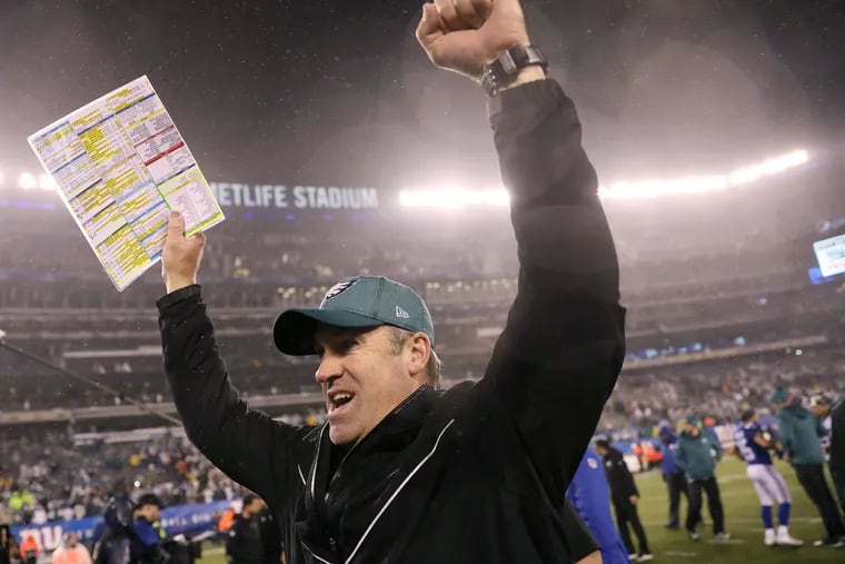 Eagles head coach Doug Pederson celebrates as he leaves the field at MetLife Stadium after Sunday's 34-17 win over the Giants, which clinched the NFC East title.