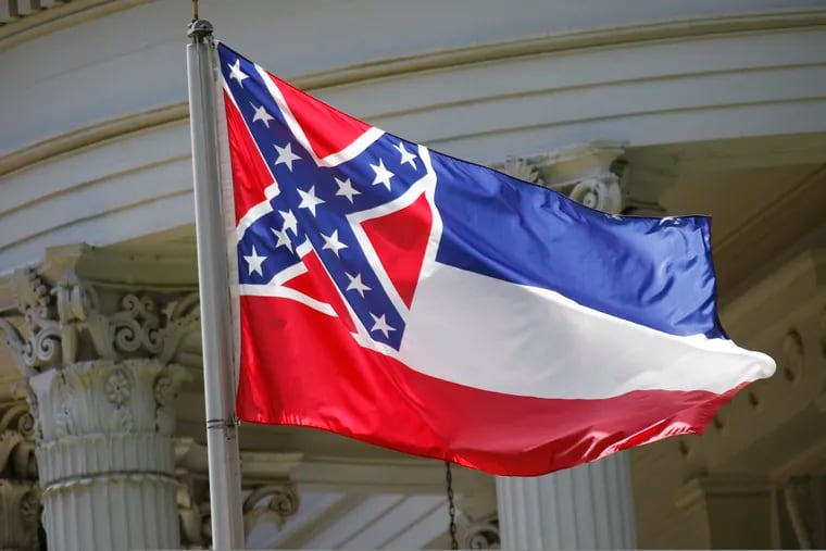 FILE - In this June 23, 2015, file photo, the state flag of Mississippi flies at the Governor's Mansion in Jackson, Miss. New Jersey Gov. Phil Murphy is ordering that the Mississippi flag be replaced by the American flag at a state park that overlooks the Statue of Liberty because it has a Confederate emblem on it.