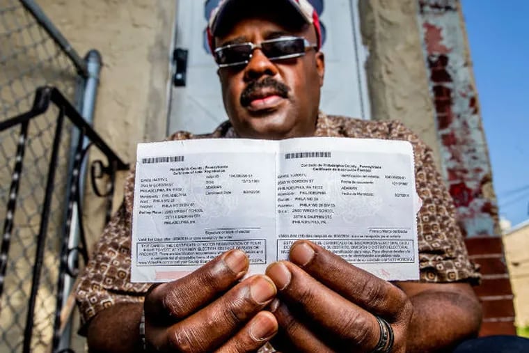 Harry Davis holds his voter-registration card, which lists him as a member of the Adarian Party. (JEFF FUSCO / FOR THE DAILY NEWS)
