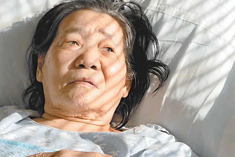 Soon Ja Kim at Abington Memorial Hospital in February. She stayed months beyond her discharge date, not visited by family and isolated by language. (TOM GRALISH / Staff Photographer)