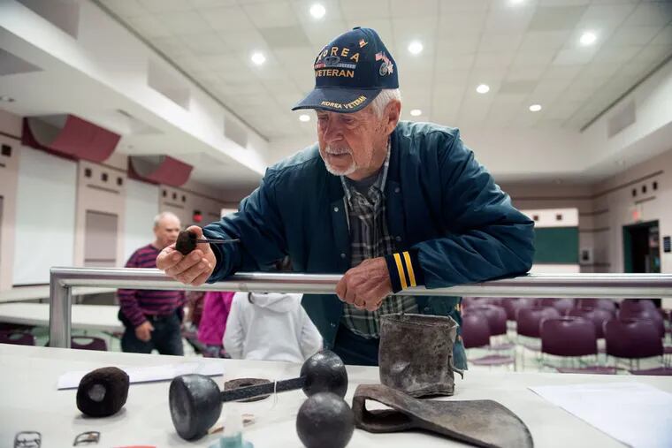 Henry Winzinger, of Jacksonville, N.J., examines a small Colonial-era cannon cleaning rod during a meeting of the South Jersey Metal Detecting Club at the Haddon Heights Police Department.