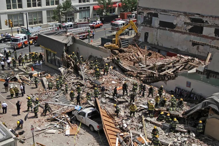 Philadelphia firefighters and police search for survivors following a wall collapse at a demolition site on Market Street that killed six people and injured many more inside a Salvation Army thrift store on May 5, 2013.