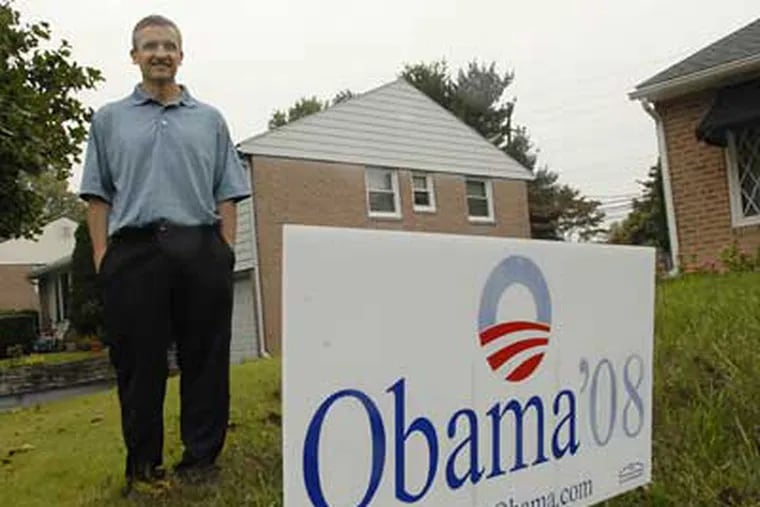 Martin Geiger stands with his Barack Obama campaign poster on the front lawn of his Springfield home.  (Jonathan Wilson/Staff Photographer)