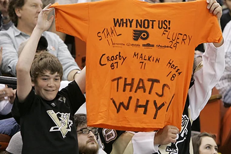 A young Penguins fan taunts the Flyers from the Mellon Arena stands. Evgeni Malkin and Jordan Staal had a goal each, while Marc-Andre Fleury stopped all 21 shots he faced in Pittsburgh's series-clinching 6-0 rout. (Gene J. Puskar/AP)