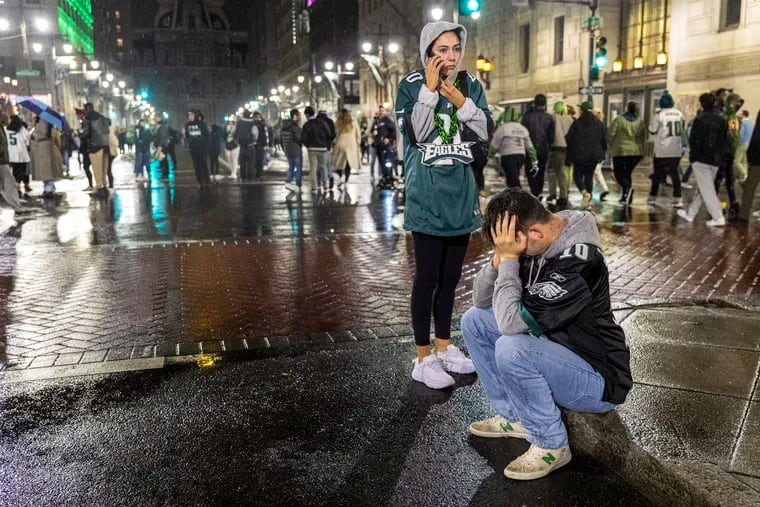 Luke Shevlin, 23, of West Chester, sits in the middle of South Broad Street on Sunday night after the Eagles lost to the Kansas City Chiefs in Super Bowl LVII.
