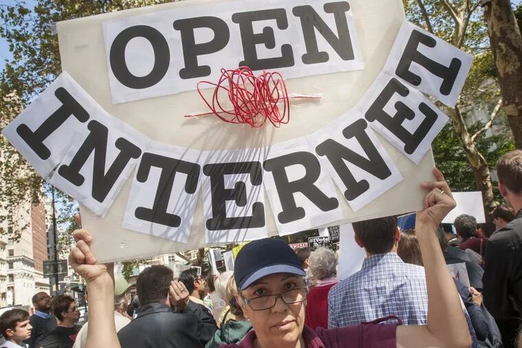 Activists protest outside of City Hall in New York in September 2014 to demand protections for Net Neutrality.