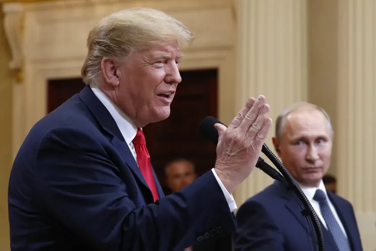 U.S. President Donald Trump speaks with Russian President Vladimir Putin during a press conference after their meeting at the Presidential Palace in Helsinki, Finland on Monday, July 16.