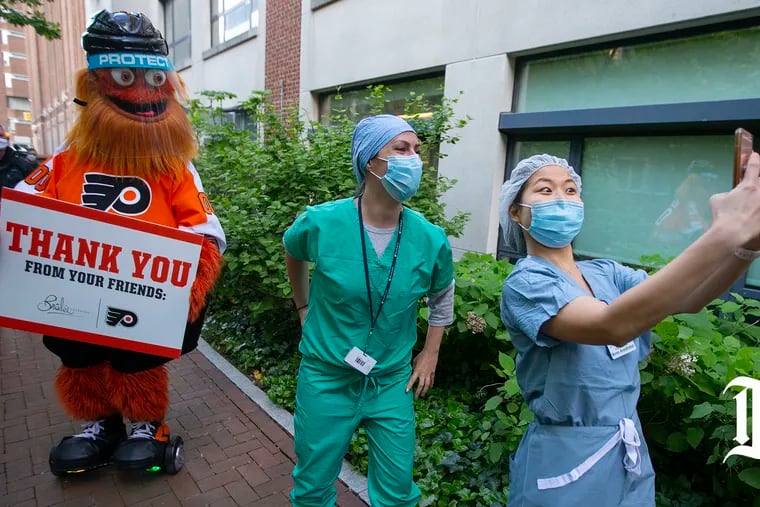 Gritty led cheers for frontline responders as they made a shift change at Hospital of the University of Pennsylvania on May 12, 2020. On Monday night, he will cheer on Penn Medicine health-care workers who will provide vaccines to any interested fan before and during the game against the New Jersey Devils.