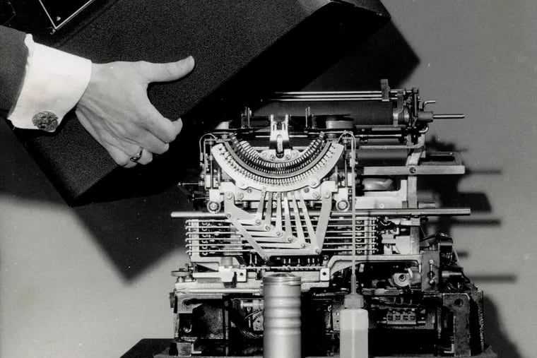 Cover being lifted from an Associated Press teletype machine, 1965. (AP Photo/Corporate Archives)