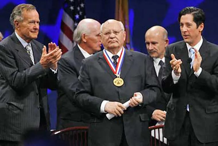 Mikhail Gorbachev is applauded by former U.S. President George H.W. Bush, left, Chairman of the National Constitution Center, and Joseph Torsella, right, president of the Center, in the awarding of the 2008 Liberty Medal. (AP Photo/Tom Mihalek)