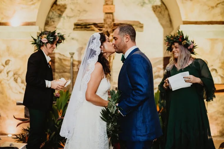 The couple married in the ruins of a chapel in a ceremony performed by their best friends. From left to right: Melanie Subacus, bride Kiki Aranita, groom Ari Miller, officiant Julia Dalton-Brush.
The maile lei worn by the groom had just been tied around the couple's hands to symbolize their union.