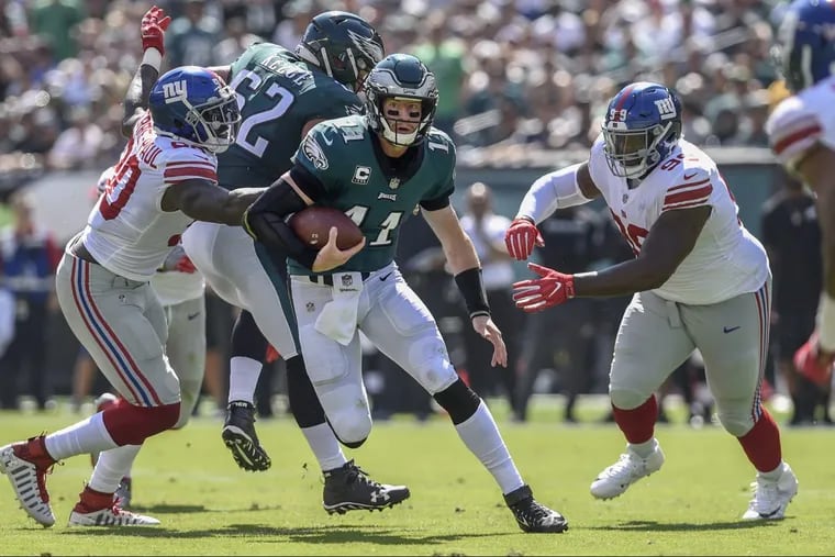Carson Wentz scrambles against the Giants in the Eagles’ 27-24 win on Sunday.