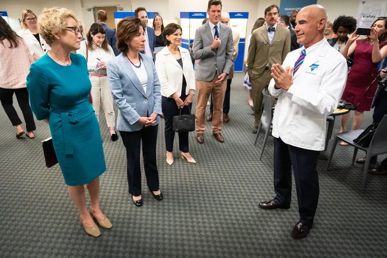 David J. Valletta, right,  Executive Vice President Sales Worldwide at Vishay Intertechnology,  conducts a tour with U.S. Secretary of Commerce Gina M. Raimondo, second from left front, and Rep. Chrissy Houlahan (D., Pa.), far left, at company headquarters in Malvern PA, Wednesday, June 01, 2022.