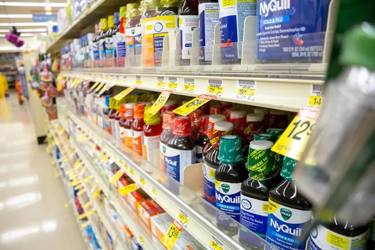 Shelves of cough medicine at a drugstore.