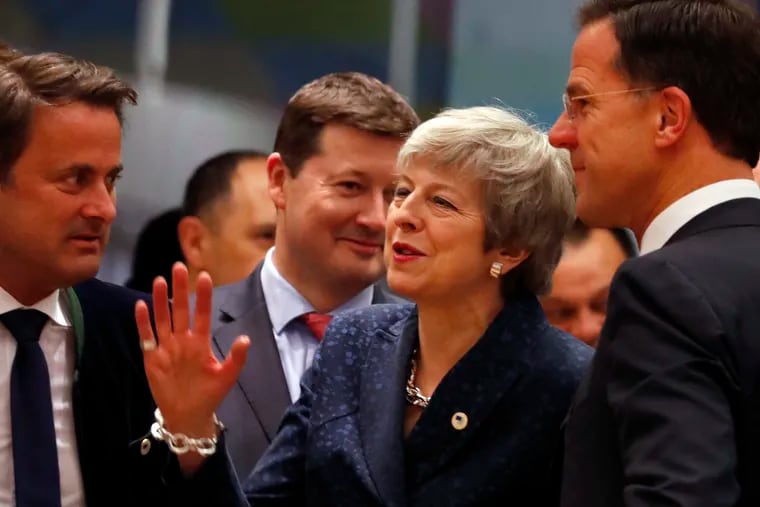 British Prime Minister Theresa May speaks with Dutch Prime Minister Mark Rutte (right) and Luxembourg's Prime Minister Xavier Bettel (left) during a roundtable meeting at an EU summit in Brussels, Thursday, March 21, 2019.