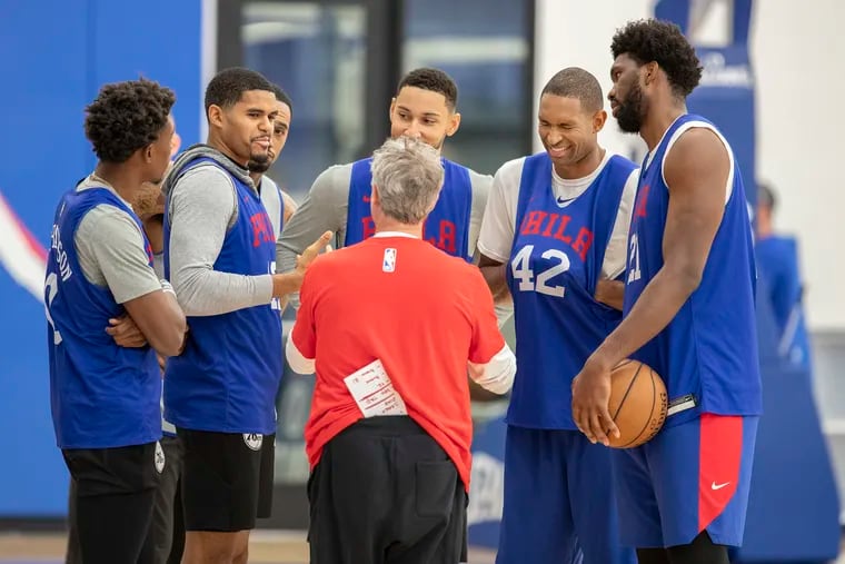 Sixers head coach Brett Brown, back to camera, holds a lighthearted discussion after practice with , left to right, Josh Richardson, Tobias Harris, Mike Scott, Tobias Harris, Ben Simmons , Al Horford, and Joel Embiid, at the Sixers practice facility.
