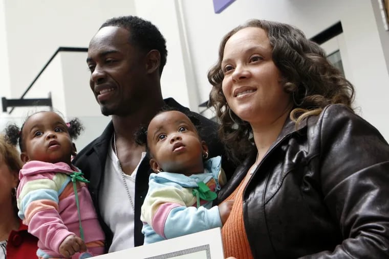 Brian Dawkins and his wife, Connie, pose with twin daughters Chionni and Cionni in May 2008, after the girls turned 1.