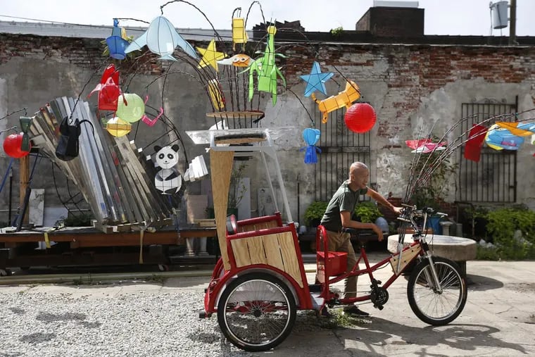 Artist Cai Guo-Qiang with one of his “Fireflies,” a pedicab illuminated with lanterns that will be used in a monthlong public art performance celebrating the Benjamin Franklin Parkway’d centennial beginning in September.