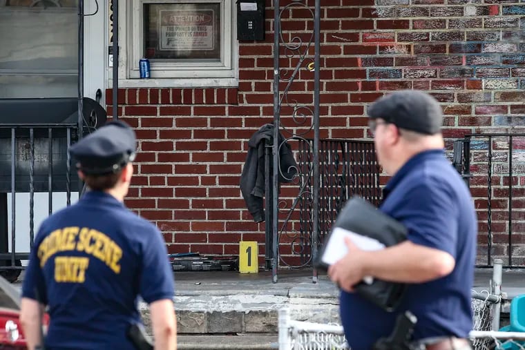 Police on the 800 block of Bridge Street where a 14-year-old boy was killed and a 15-year-old girl was wounded in a shooting Friday afternoon in Philadelphia's Summerdale neighborhood.