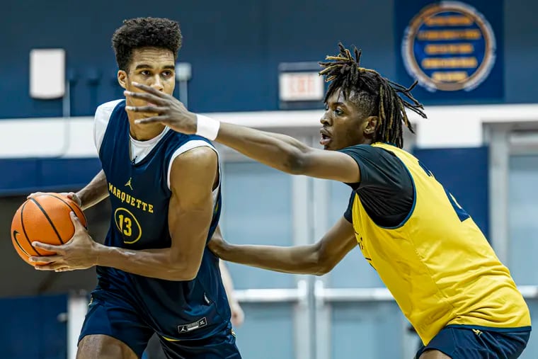 Marquette's Al Amadou defends senior Oso Ighodaro during practice in October. Ighodaro has been a mentor to Amadou, a Philly native.