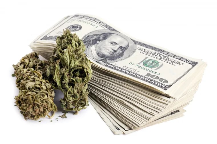 Marijuana buds and a stack of $100 bills.