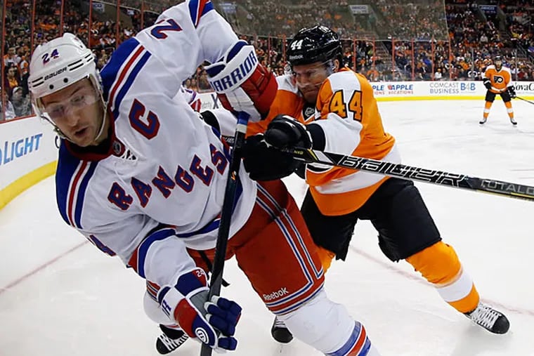 Kimmo Timonen, right, shoves New York Rangers' Ryan Callahan into the corner during the first period of an NHL hockey game, Saturday, March 1, 2014, in Philadelphia. (Matt Slocum/AP)