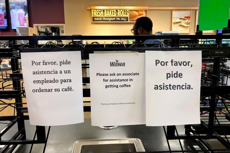 Signs in the Wawa in Woolwich Twp, N.J. Mar. 24, 2020 reflected the company's suspension of self-service coffee service. A Wawa associate instead poured out the coffee for customers because of the coronavirus pandemic.