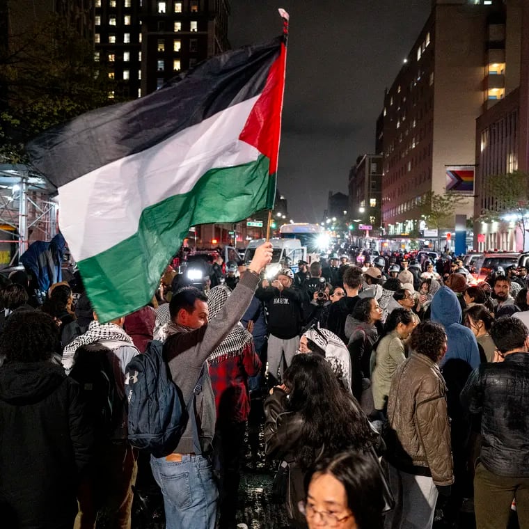 Pro-Palestinian protesters gather near an area where people were being taken into custody near the Columbia University campus in New York on Tuesday after a campus encampment and a campus building, taken over by protesters earlier in the day, were cleared by New York City police.