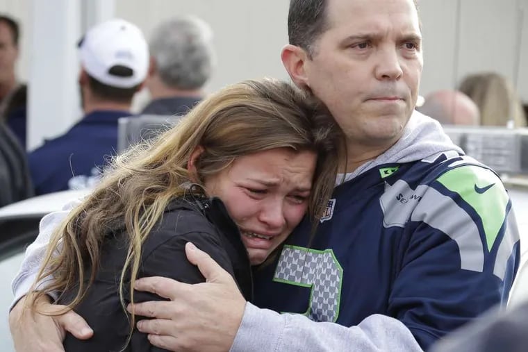 In Marysville, Wash., reunited students and parents wait at a church. Four other students were wounded. He &quot;was just staring down every one of his victims as he shot them,&quot; said a student.