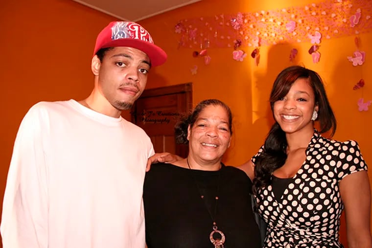 Khasiem Carr (left) with his mother, Karen (center), and older sister, Laquita, at a birthday party in West Philadelphia around 2009. (L's & J's Creations Photography)