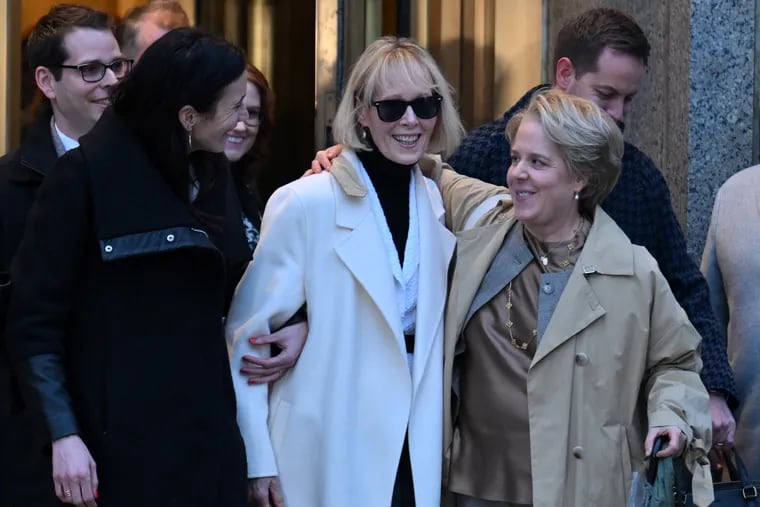 Writer E. Jean Carroll (center) leaves federal court Friday in New York after the verdict was announced in her defamation case against former President Donald Trump.